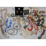 A collection of vintage costume jewellery to include diamante clips, a First Nation leather and