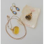 A 9ct gold smoky quartz fob seal on original card, together with a further example set with yellow