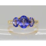 An 18ct gold tanzanite and diamond ring, central tanzanite approx 7.9mm x 6.1mm, diamond content