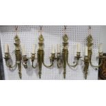 A set of four French gilt metal wall sconces with flame finials, 48cm high Condition Report: Not