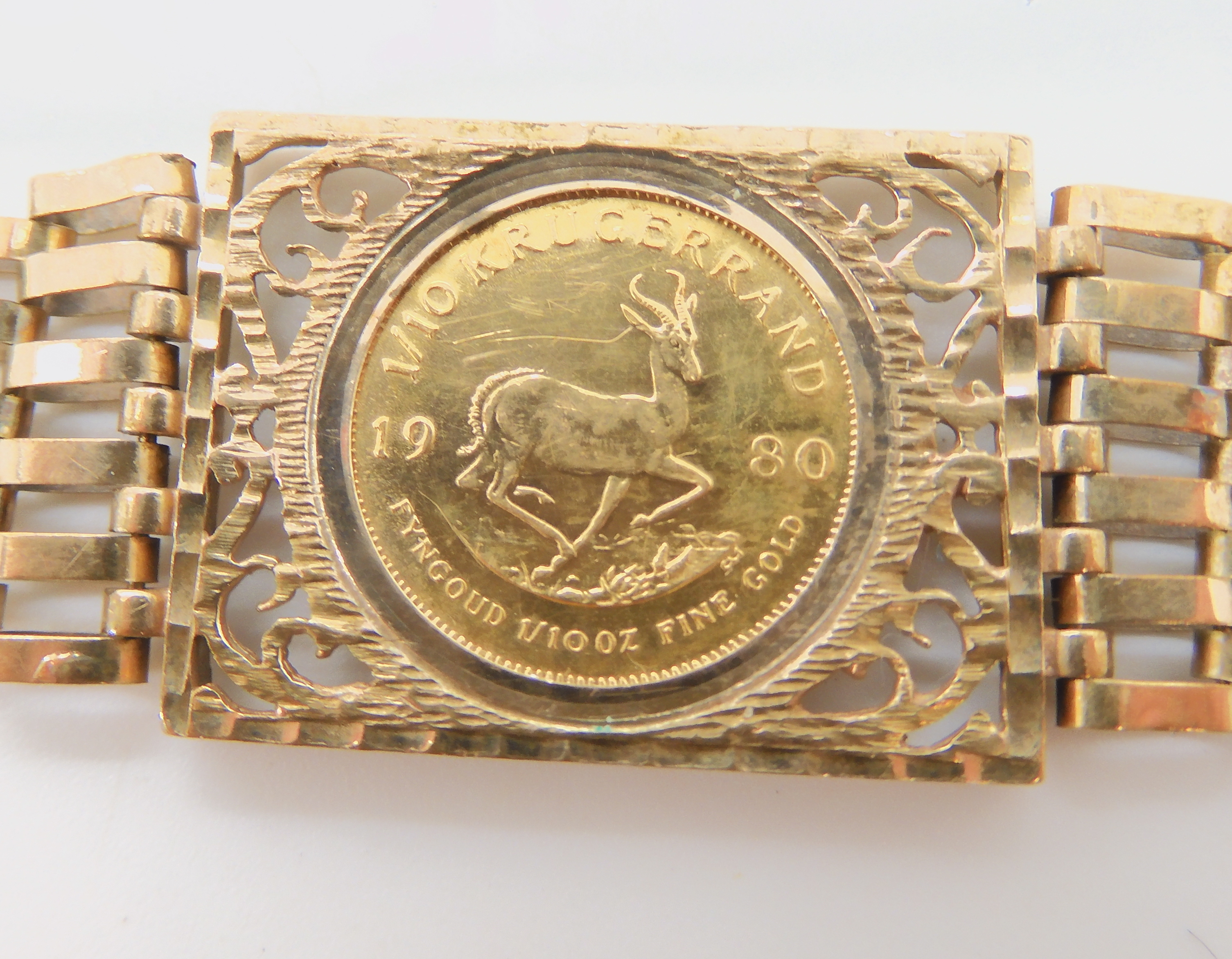 A 9ct gold gate bracelet set with a 1980 1/10th Krugerrand coin, weight combined 13.8gms there is no - Image 3 of 3