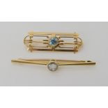 A 15ct gold aquamarine set bar brooch, weight 3.1gms and a 14k gold blue zircon brooch, weight