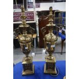 A pair of gilded metal urn shaped table lamps, 70cm high Condition Report: Available upon request