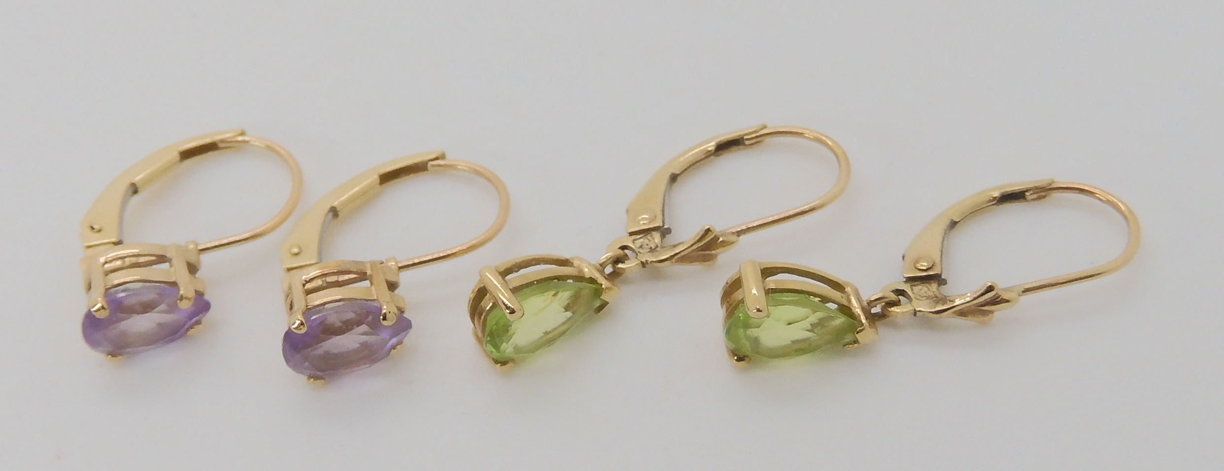 A pair of 9ct gold peridot earrings together with a pair of amethyst earrings, weight combined 2.