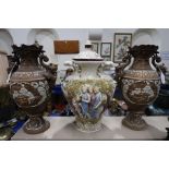 A pair of continental ceramic vases with tavern scenes in relief together with a classical themed