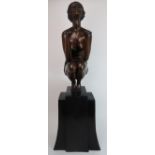 A LARGE ART DECO STYLE BRONZED METAL FIGURE modelled as a semi nude woman crouching with upturned