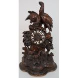 A LATE 19TH CENTURY BLACK FOREST CLOCK carved with two large grouse and three smaller, the dial with