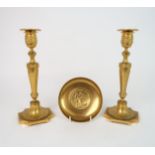 A PAIR OF GILT BRONZE BARBEDIENNE CANDLESTICKS of classical design with a band of putti under the