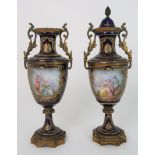 A PAIR OF FRENCH SEVRES STYLE GILT METAL MOUNTED URNS the cobalt blue ground painted with cartouches