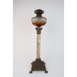 A VICTORIAN OIL LAMP the onyx column with brass acanthus top and stepped square base on four paw