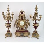 AN ITALIAN IMPERIAL CLOCK GARNITURE the dial with Roman numerals, standing on gilt metal and