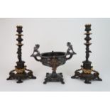 A PAIR OF CLASSICAL STYLE PATINATED CANDLESTICKS each with gilded rose swag detail, a putto and a