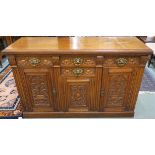 An oak carved sideboard with four drawers over three doors, 96cm high x 152cm wide x 54cm deep (def)