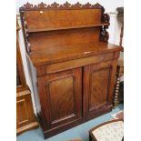 A Victorian mahogany chiffonier with carved back over a base with two doors and frieze drawer, 151