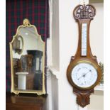 An oak barometer and a wall mirror (2) Condition Report: Available upon request