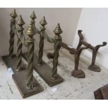 A pair of brass fire dogs and a pair of wrought iron fire dogs Condition Report: Available upon