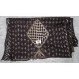 A brown Egyptian Assuit shawl with gilt metal decoration, 245cm x 47cm Condition Report: Not