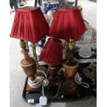 A pair of brass table lamps with triform bases, together with a pair of brown alabaster lamps and