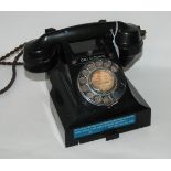 A vintage black Bakelite telephone Condition Report: Available upon request