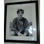 A large black and white photograph of George Best bearing an autograph, 71 x 61cm overall