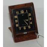 An Eight Day Le Coultre travel clock in leather case Condition Report: Available upon request