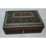 An early carved Indian sewing box with ivory inlay decoration and carved animals, fitted