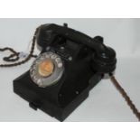 A vintage black Bakelite telephone Condition Report: Available upon request