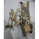 a selection of gilt metal easels with scrolling foliage motifs, a wooden example, and a table runner