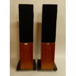A pair of Linn Kaber 013395 speakers on plinths with a natural finish, bearing makers mark Gordon
