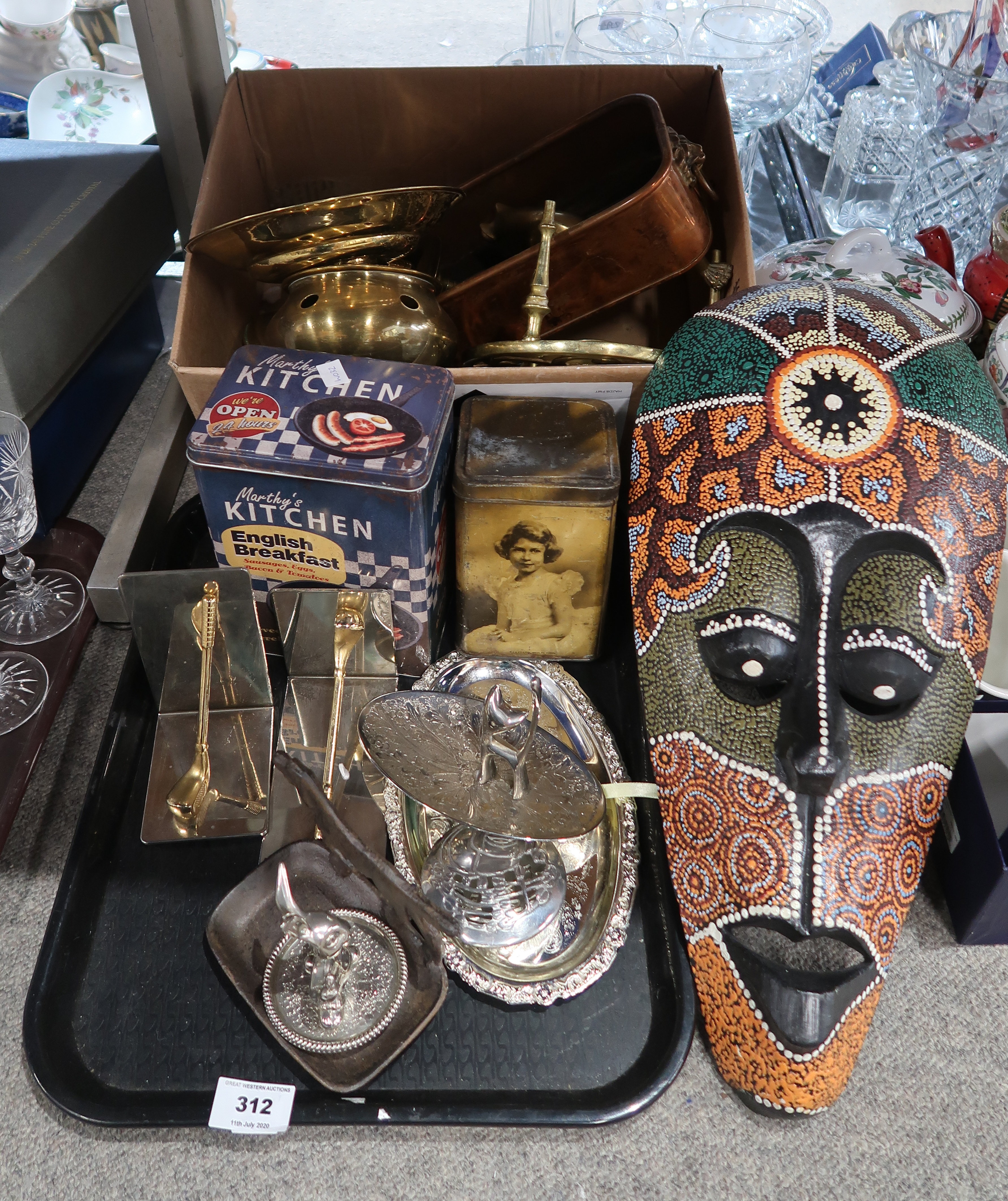 A painted wooden ethnic mask, storage tins, golf club book ends, white metal trinket dishes,