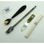 A lot comprising a cigarette holder, a letter opener, a pickle fork & a roller tool Condition