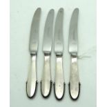 A lot comprising four Georg Jensen silver handled travel knives in the beaded pattern 16.5cm long