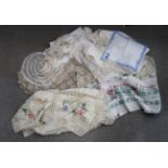 A quantity of embroidered table linen, covers, tablecloths, doilies etc Condition Report: Not