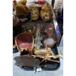 A selection of gilt wooden sculptures of deer, a butterfly, a flashed amber glass jug, a mottled