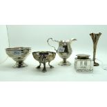 A lot comprising a silver topped inkwell London 1896, a silver cream jug, Chester 1904, a salt and a