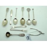 A lot comprising assorted silver spoons, a silver butter knife and a pair of tongs modelled as a