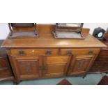 An oak sideboard with two frieze drawers over three doors, 113cm high x 168cm wide x 58cm deep