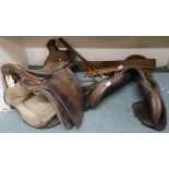 Two leather saddles and a leather strap (3) Condition Report: Available upon request
