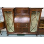 A mahogany bureau with drop front , two drawers over two doors flanked by glazed doors on ball and