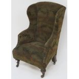 A childs wingback upholstered armchair with ceramic castors, 72cm high Condition Report: Available