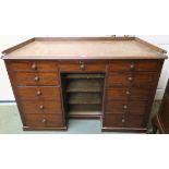 A Victorian mahogany trapezoid shaped desk desk with various depth drawers, 87cm high x 130cm wide x