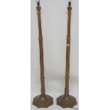 A pair of carved oak standard lamps (2) Condition Report: Available upon request