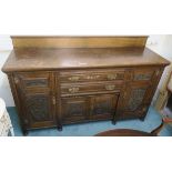 An oak sideboard with two drawers over two carved doors flanked by two carved doors, 114cm high x