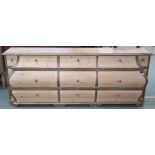 A modern limed pine bombe shaped sideboard with nine drawers, retailed by Design Works, Interior