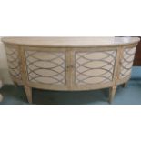 A modern limed pine bow front sideboard with four doors with the top having a textured finish with