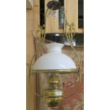 A brass hanging oil lamp with white shade Condition Report: Available upon request