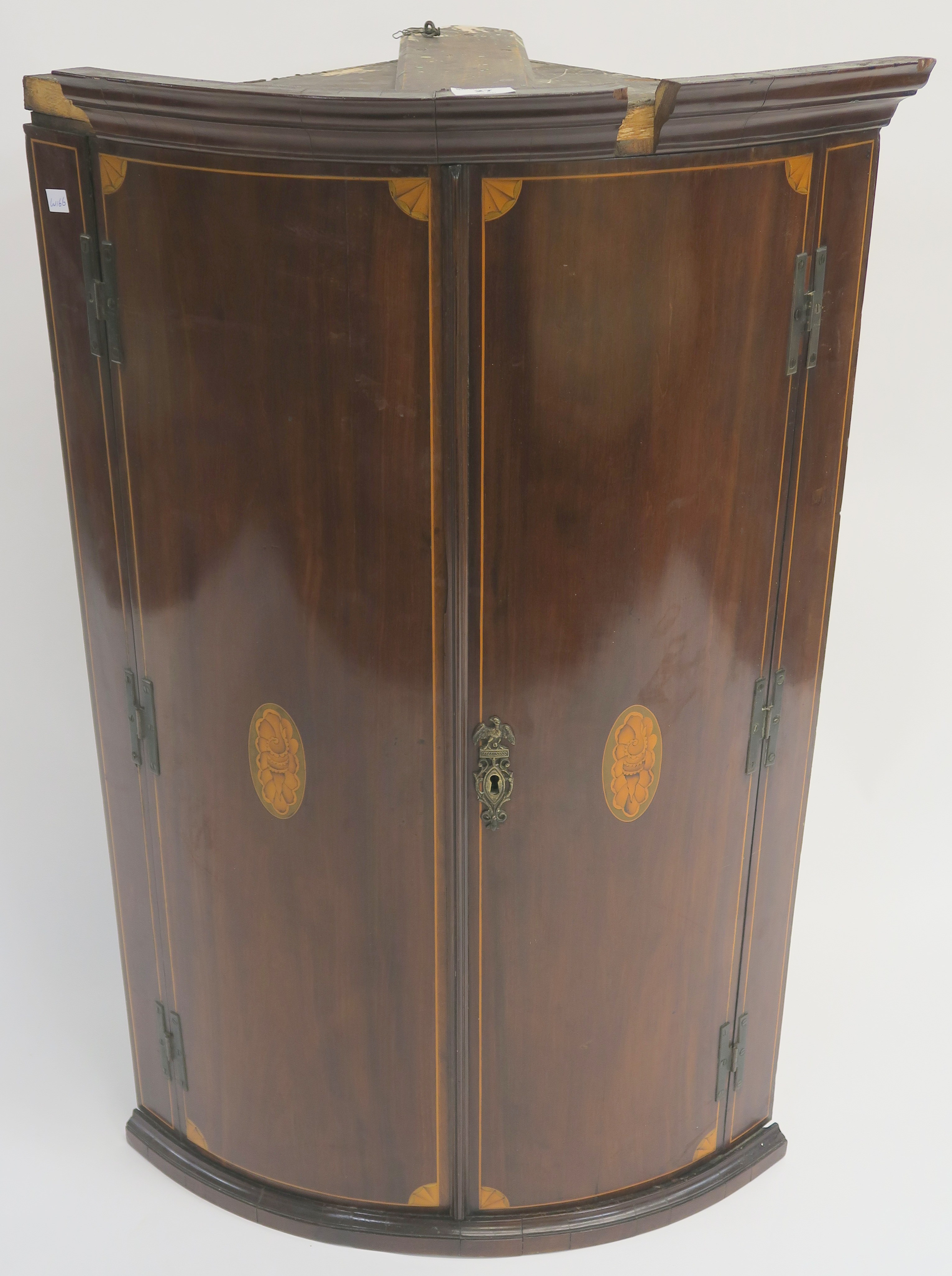 A Georgian mahogany inlaid bow front corner cabinet, 102cm wide x 64cm wide x 47cm deep Condition
