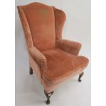 A pink upholstered wing back armchair, 114cm high Condition Report: Available upon request