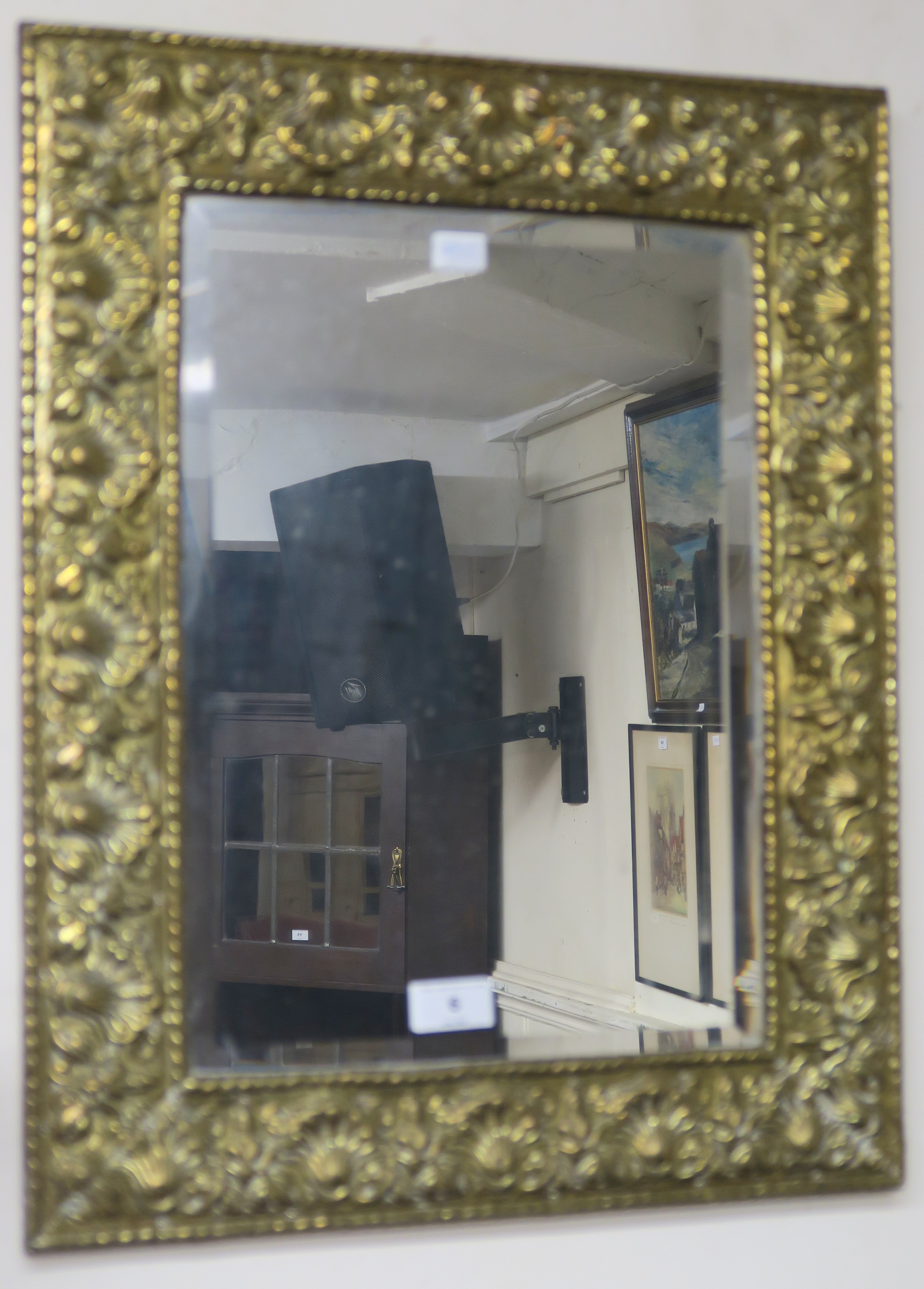 A brass wall mirror with bevelled glass, 56cm x 44cm Condition Report: Available upon request