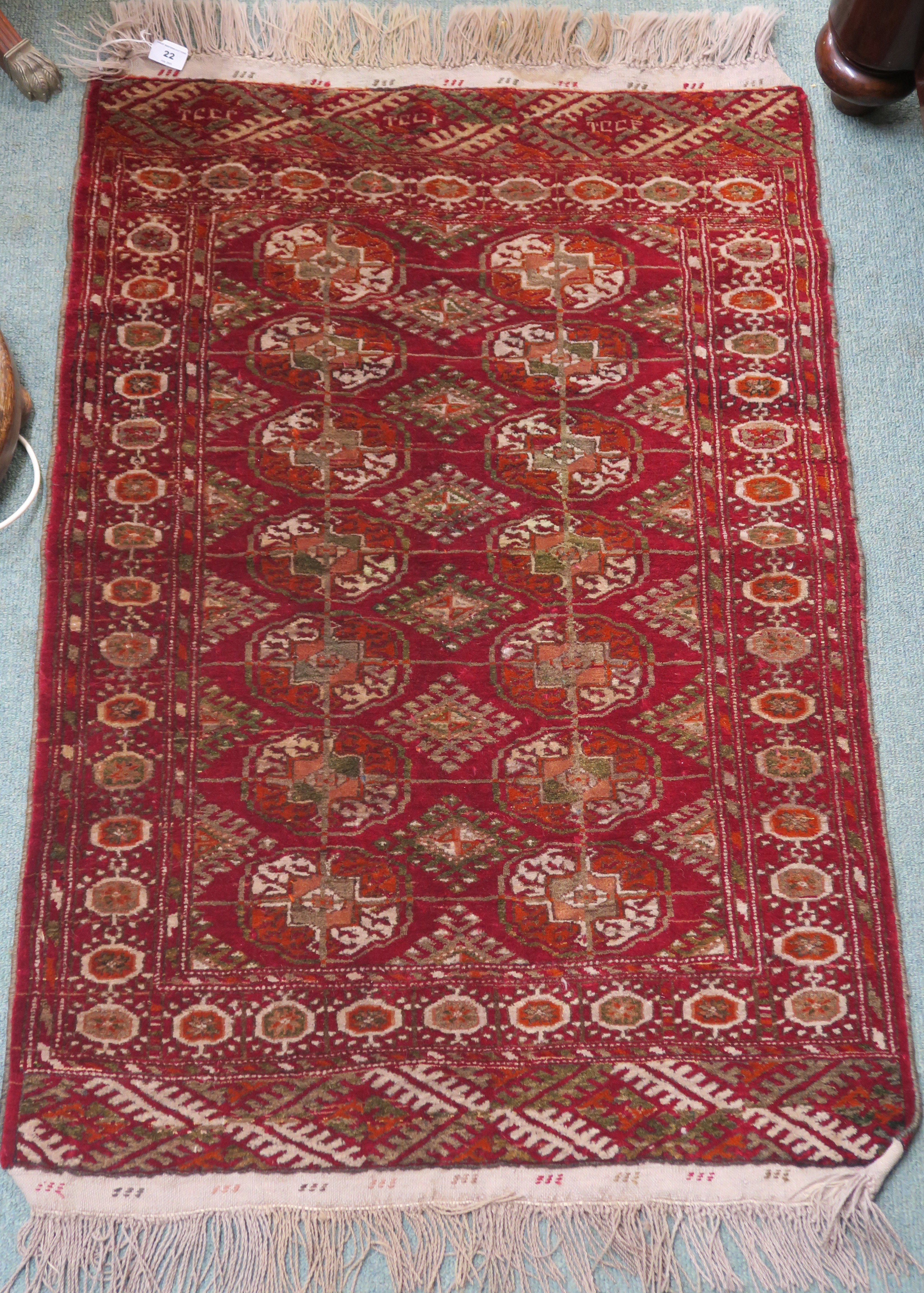 A red ground Turkeman style rug, 114cm x 80cm Condition Report: Available upon request